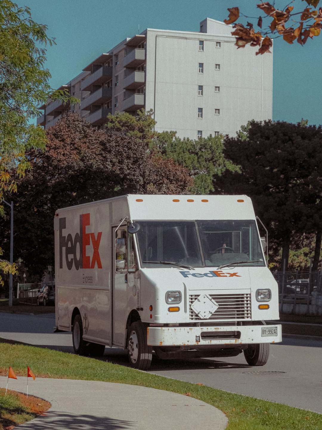 delivery truck parked on suburban street under clear sky in autumn